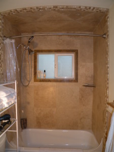 Travertine shower with radius ceiling